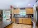Bright kitchen with stainless steel appliances, dark countertops, and ample cabinet space at 750 Eden Pl, The Villages, FL 32162