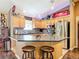 Kitchen island with barstool seating, stainless steel appliances, and vintage decorative signage at 750 Eden Pl, The Villages, FL 32162