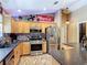 Well-lit kitchen features stainless steel appliances, granite countertops, and decorative vintage accents at 750 Eden Pl, The Villages, FL 32162