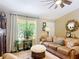 Cozy living room with a comfortable leather sofa, soft rug, and a decorative birdcage with plants at 750 Eden Pl, The Villages, FL 32162