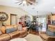 Spacious living room with a leather sofa, vaulted ceilings, and a view of the dining area and screened patio at 750 Eden Pl, The Villages, FL 32162
