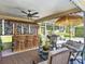 Tropical paradise featuring a tiki bar, outdoor seating, and a screened-in pool for ultimate relaxation and entertainment at 750 Eden Pl, The Villages, FL 32162