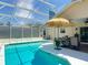Relaxing screened pool with an adjacent patio area, providing a perfect spot for leisure and entertaining guests at 750 Eden Pl, The Villages, FL 32162