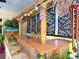 Patio tiki bar with tiki decorations and bar stools at 750 Eden Pl, The Villages, FL 32162