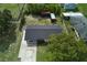 Aerial view of home, showing the roof, surrounding neighborhood and lush greenery at 841 S Michigan Ave, Groveland, FL 34736
