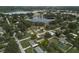 Aerial shot of the property highlighting the home's location, landscaping, and proximity to a lake at 841 S Michigan Ave, Groveland, FL 34736