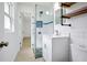 Updated bathroom with glass shower, stone floor, and rustic wood shelving at 841 S Michigan Ave, Groveland, FL 34736