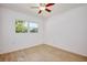 Bright bedroom featuring light wood floors, a ceiling fan, and a large window overlooking the backyard at 841 S Michigan Ave, Groveland, FL 34736