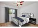 Well-lit bedroom featuring neutral paint, wood floors and modern furnishings at 841 S Michigan Ave, Groveland, FL 34736