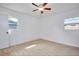 Light and airy bedroom with neutral walls, ceiling fan, light wood floors and natural light from two windows at 841 S Michigan Ave, Groveland, FL 34736