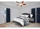 Comfortable bedroom with a ceiling fan, wood floors, and bright natural light at 841 S Michigan Ave, Groveland, FL 34736