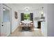 Charming dining area features modern decor, a round table with seating for four, and large windows at 841 S Michigan Ave, Groveland, FL 34736