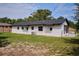 Rear exterior of home with fenced-in yard and screened porch, offering privacy and outdoor living at 841 S Michigan Ave, Groveland, FL 34736
