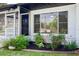 Inviting front porch features a small garden and a view into the living area at 841 S Michigan Ave, Groveland, FL 34736