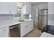 Bright kitchen features stainless steel appliances, modern white cabinets, and quartz countertops at 841 S Michigan Ave, Groveland, FL 34736