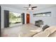 Modern living room showcases a comfortable seating arrangement, large windows, and light wood floors at 841 S Michigan Ave, Groveland, FL 34736