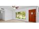 Bright living room featuring light wood floors, ceiling fan and a large window offering an abundance of natural light at 841 S Michigan Ave, Groveland, FL 34736