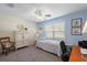 Cozy bedroom with neutral carpet, ceiling fan, and natural light from the window at 851 Evelynton Loop, The Villages, FL 32162