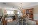 Charming dining area with a round table, classic chandelier, and vintage hutch at 851 Evelynton Loop, The Villages, FL 32162