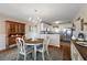 Cozy dining area next to the kitchen features a chandelier and a china cabinet at 851 Evelynton Loop, The Villages, FL 32162