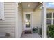 Inviting front door with decorative glass, sheltered by a charming portico and white pillars at 851 Evelynton Loop, The Villages, FL 32162