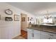 Open kitchen area featuring granite counters and a breakfast bar overlooking living space at 851 Evelynton Loop, The Villages, FL 32162