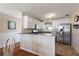 Stylish kitchen featuring a breakfast bar, granite counters, stainless appliances, and wainscoting at 851 Evelynton Loop, The Villages, FL 32162
