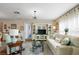 Bright living room with stylish decor, neutral colors, and lots of natural light at 851 Evelynton Loop, The Villages, FL 32162