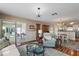 Inviting living room flows into the dining area and features a sliding glass door to the outdoor space at 851 Evelynton Loop, The Villages, FL 32162