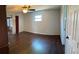 This primary bedroom features hardwood floors, a ceiling fan and a large window at 901 Baylor Dr, Deltona, FL 32725