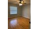 Bedroom features neutral paint, and a window offering natural light and a ceiling fan at 901 Baylor Dr, Deltona, FL 32725