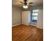 Bedroom with wood flooring, and ample storage space with a closet and a window at 901 Baylor Dr, Deltona, FL 32725