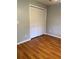 Bedroom with wood flooring, and ample storage space with a closet at 901 Baylor Dr, Deltona, FL 32725