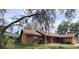 Quaint single-story home with brick accents and mature landscaping at 901 Baylor Dr, Deltona, FL 32725
