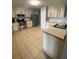 Traditional kitchen with stainless steel appliances, tile flooring and two toned cabinets at 901 Baylor Dr, Deltona, FL 32725
