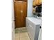 Laundry room with tile floor, wooden door, washer and dryer at 901 Baylor Dr, Deltona, FL 32725