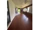 Bright sunroom with hardwood floors, sliding doors, and a cozy fireplace at 901 Baylor Dr, Deltona, FL 32725