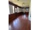 Large sunroom with wood paneling, hardwood floors and lots of light at 901 Baylor Dr, Deltona, FL 32725