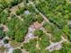 Aerial shot of property showcases privacy amidst a canopy of trees, highlighting the expansive property lines at 9144 Sw 156Th Pl, Dunnellon, FL 34432