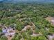 Aerial perspective features a property nestled in dense foliage with clearly delineated land lines, offering seclusion at 9144 Sw 156Th Pl, Dunnellon, FL 34432