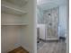 Bathroom with a tiled shower and an open storage area for linens and bath essentials at 9144 Sw 156Th Pl, Dunnellon, FL 34432