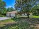 Charming home with an arched doorway and mature landscaping and trees at 9144 Sw 156Th Pl, Dunnellon, FL 34432