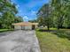 Charming home with large driveway, green lawn, and established trees at 9144 Sw 156Th Pl, Dunnellon, FL 34432