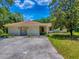 Close exterior shot shows a front view of a home with an arched front door at 9144 Sw 156Th Pl, Dunnellon, FL 34432