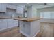 Modern kitchen with white cabinets and an island with butcher block counter top at 9144 Sw 156Th Pl, Dunnellon, FL 34432