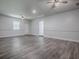The living room includes modern grey wood-look flooring, a ceiling fan, and access to other rooms at 9144 Sw 156Th Pl, Dunnellon, FL 34432