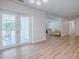 Spacious sun room flows into the living room with light wood flooring and lots of natural light at 9144 Sw 156Th Pl, Dunnellon, FL 34432