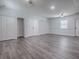 Large living room area featuring multiple closets, a ceiling fan, and modern gray wood-look flooring at 9144 Sw 156Th Pl, Dunnellon, FL 34432