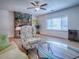 Bright living room with a stone fireplace, large window, and stylish, comfortable furniture at 9144 Sw 156Th Pl, Dunnellon, FL 34432