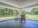Relaxing covered porch with rocking chairs that offers a peaceful view of the surrounding landscape at 9144 Sw 156Th Pl, Dunnellon, FL 34432